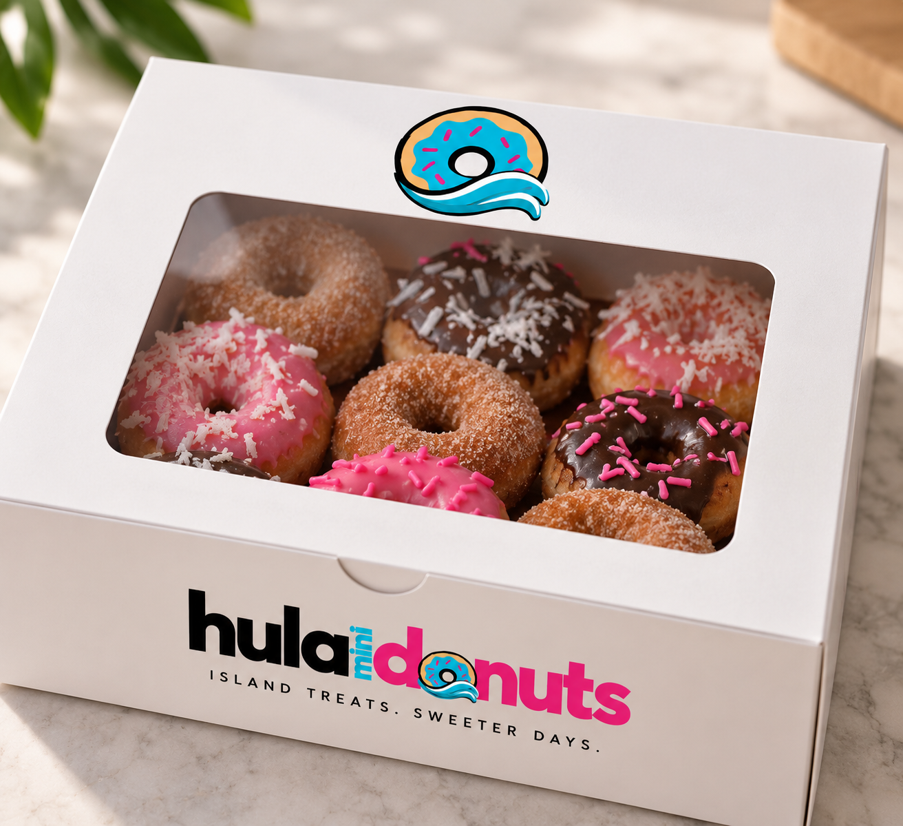 White Hula Mini Donuts window box filled with cinnamon sugar, pink coconut and chocolate mini donuts